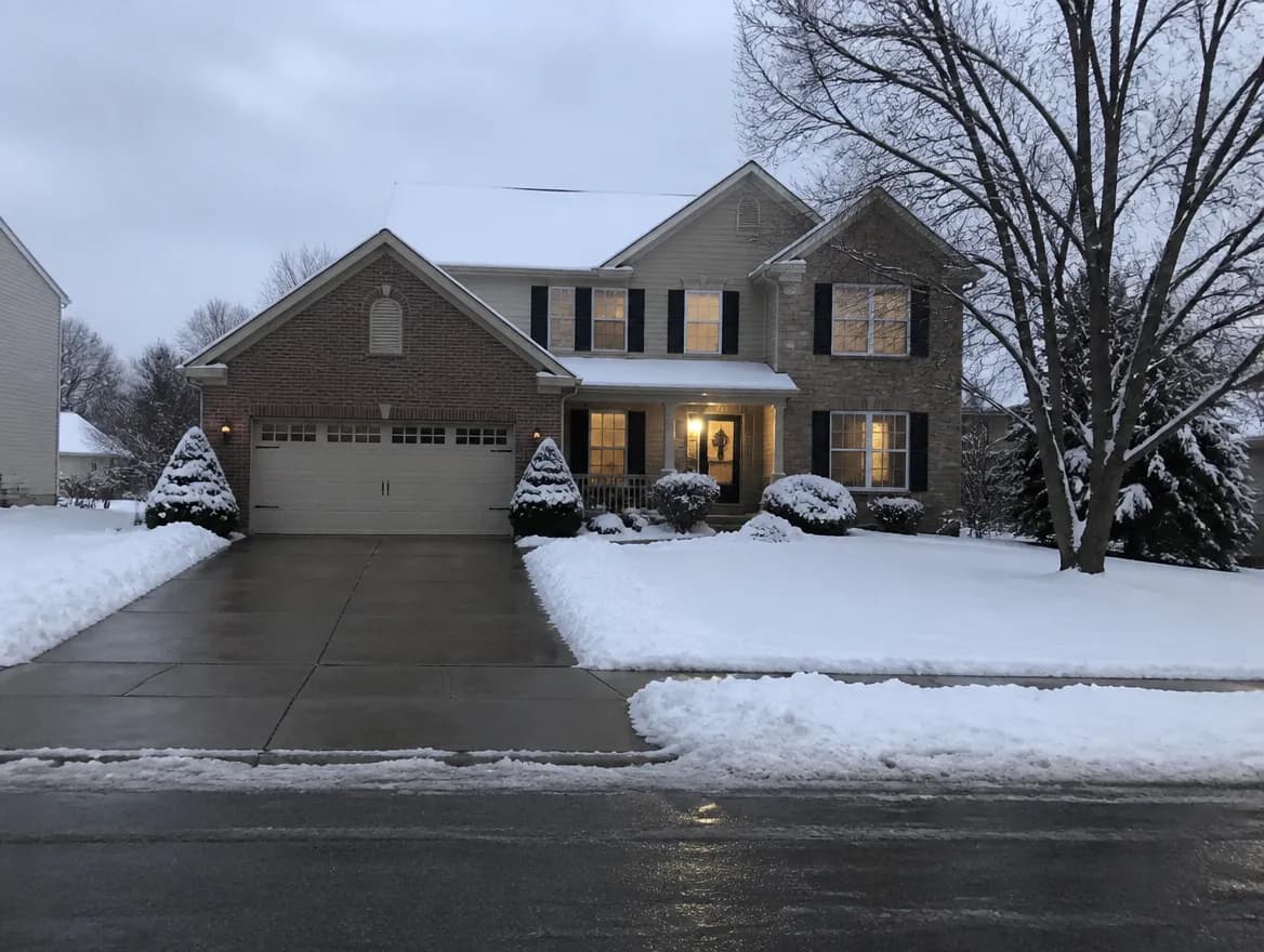 A cleared driveway and walk in front of a brick home